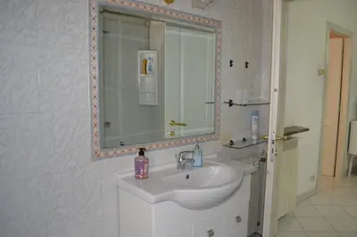 a white bathroom with a sink and a mirror at Perla Vaticana in Rome