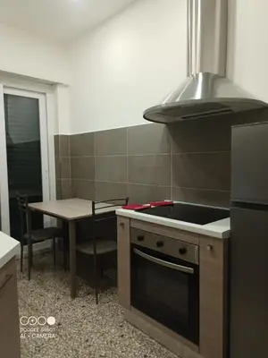 a kitchen with a stove top oven and a table at Domus Gianicolense in Rome