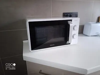 a microwave oven sitting on top of a counter at Domus Gianicolense in Rome