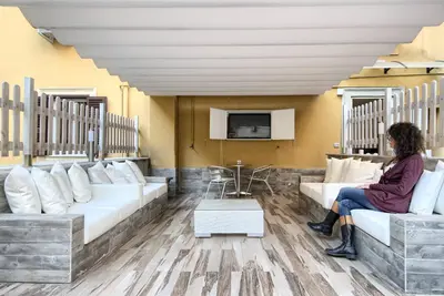 a woman sitting on a couch in a living room at Vatican's Roof in Rome