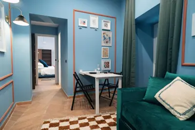 a living room with a green couch and a table at Victorian House, Rome Center in Rome