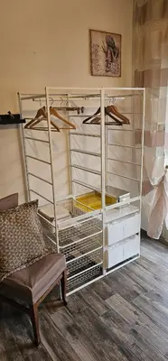 a room with a glass closet with hangers and a chair at Corona House in Rome