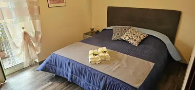 a bedroom with a bed with two towels on it at Corona House in Rome