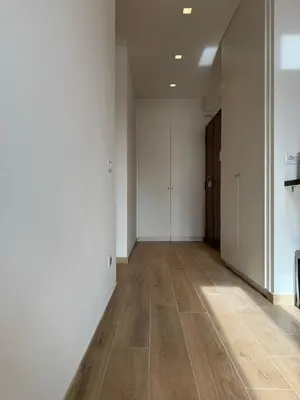 an empty hallway with white walls and wooden floors at San Lorenzo House in Rome