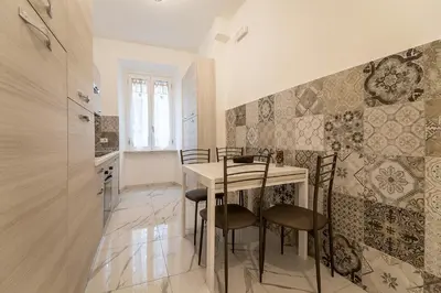 a kitchen with a table and chairs in a room at TERMINI HOLIDAY in Rome