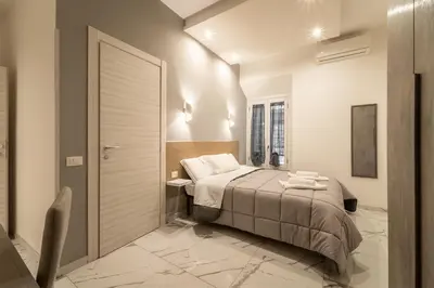 a bedroom with a bed and a sliding door at TERMINI HOLIDAY in Rome