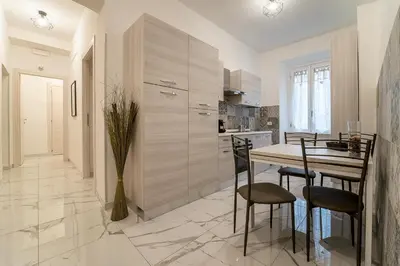 a kitchen with a table and chairs in a room at TERMINI HOLIDAY in Rome