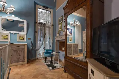 a living room with blue walls and a television at Rome as you feel - Vicolo delle Grotte in Rome