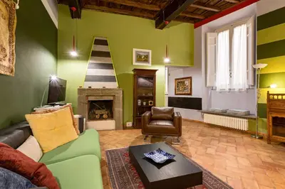 a living room with a couch and a fireplace at Rome as you feel - Vicolo delle Grotte in Rome