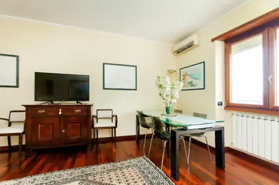 a living room with a tv and a table and a tvictericterictericter at Appia Nuova Lucrezia Apartment in Rome