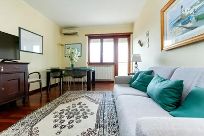 a living room with a couch and a table at Appia Nuova Lucrezia Apartment in Rome