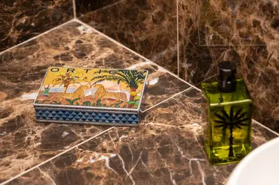 a bottle of oil next to a box on a counter at Residenza Pierret in Rome