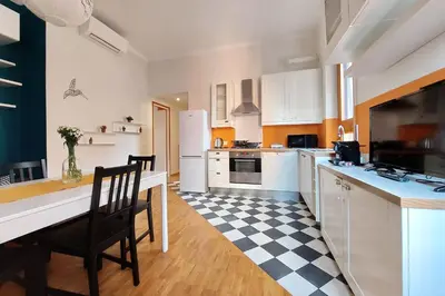a kitchen with a black and white checkered floor at Monteverde family apartment in Rome