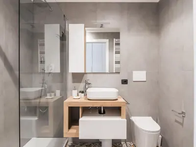 a bathroom with a sink and a toilet and a mirror at The Best Rent - Three-bedroom apartment near Piazza Barberini in Rome
