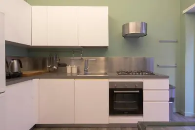 a kitchen with white cabinets and a sink at Domus Rinascimento (Piazza Navona) in Rome