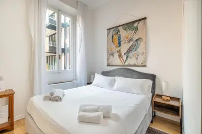 a bedroom with a white bed with towels on it at Saturno in Trevi in Rome
