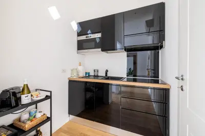 a kitchen with black cabinets and a counter top at Saturno in Trevi in Rome