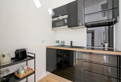 a kitchen with stainless steel appliances and a counter at Saturno in Trevi in Rome