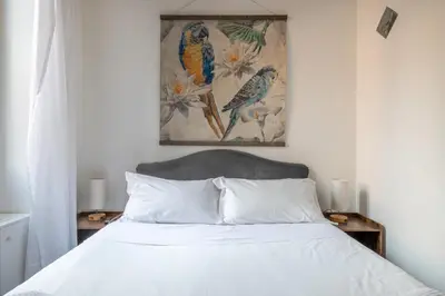 a bedroom with a bed with a painting above it at Saturno in Trevi in Rome