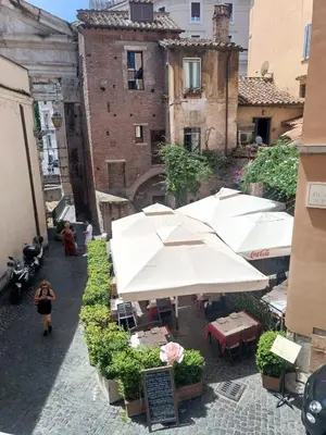 a group of tables with umbrellas in an alley at Marcello Apartament in Rome