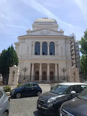 a large building with cars parked in front of it at Marcello Apartament in Rome