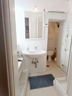 a white bathroom with a sink and a toilet at Marcello Apartament in Rome