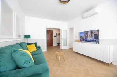 a living room with a green couch and a table at Vatican City Apartment in Rome