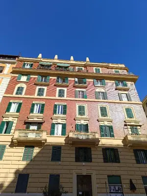 a tall brick building with windows on it at Gay House Roma - Only Gay in Rome