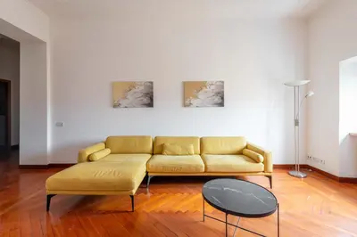 a living room with a yellow couch and a table at AppleMoon2.0 in Rome