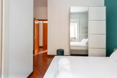 a bedroom with a white bed and a mirror at AppleMoon2.0 in Rome