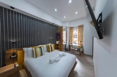 a bedroom with a bed with white towels on it at Cola Suites Apartments in Rome