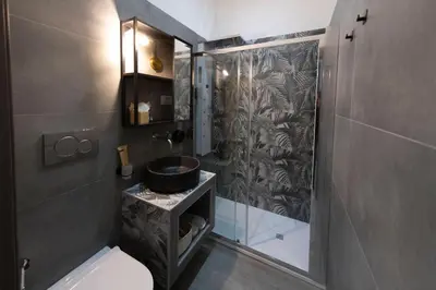a bathroom with a toilet and a sink and a shower at Cola Suites Apartments in Rome