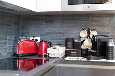 a kitchen counter with a red appliance on it at Cola Suites Apartments in Rome