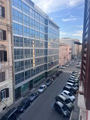 a parking lot with cars parked in front of a building at Palestro 78 in Rome
