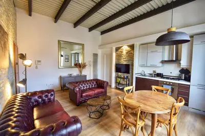 a living room with a couch and a table at Industrial Loft Trastevere Station in Rome