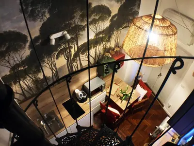 an overhead view of a living room with a painting on the wall at Grottino 3a Apartment in Rome