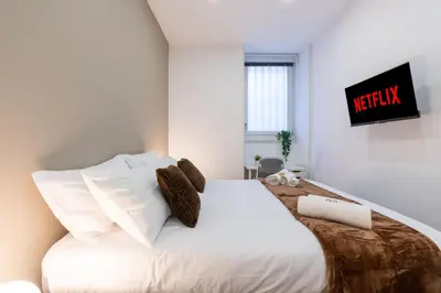 a bedroom with a bed with white sheets and pillows at PL Guest House in Rome