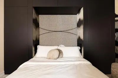 a bed with a headboard with a pillow on it at Via Veneto Supreme Terrace in Rome
