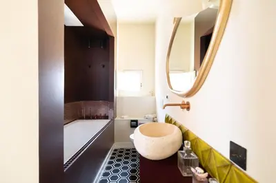a bathroom with a round sink and a mirror at Via Veneto Supreme Terrace in Rome