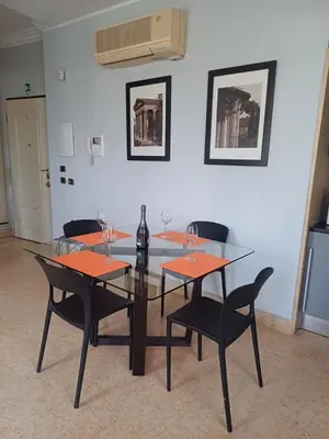 a dining room with a glass table and chairs at La Casetta di Miriam a Piazza di Spagna in Rome