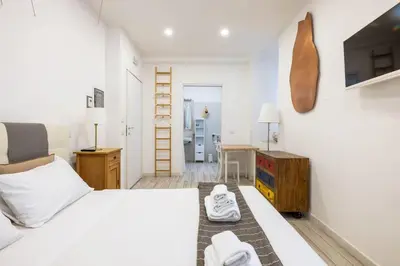 a bedroom with a bed and a desk and a ladder at Vatican Momahouse Luxury by Varental in Rome