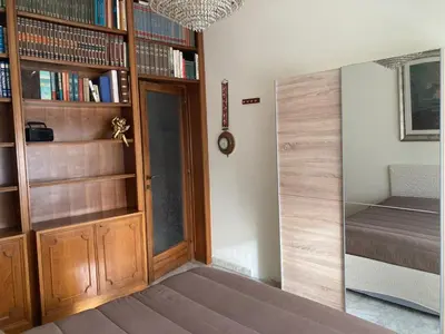 a room with a bed and a book shelf with books at Le Mille e Una Notte in Rome