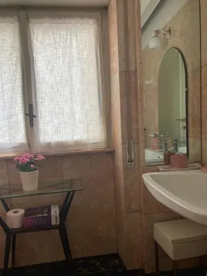 a bathroom with a sink and a tub and a mirror at Le Mille e Una Notte in Rome