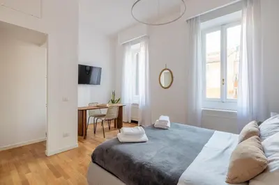 a bedroom with a bed and a desk in it at Venere in Trevi in Rome