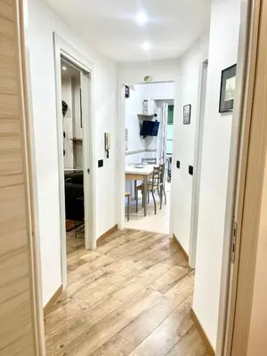 a hallway with white walls and wooden flooring in a house at 15 Min. Colosseo 2 - Casa di Micca in Rome