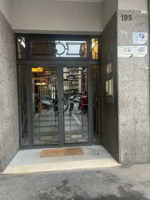an entrance to a building with a glass door at 15 Min. Colosseo 2 - Casa di Micca in Rome
