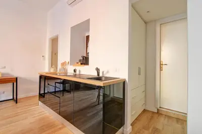 a kitchen with a table and a sink in a room at Giove in Trevi in Rome
