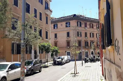 a city street with cars parked in front of buildings at Pigneto Easy Stay in Rome