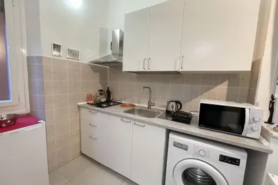 a kitchen with a sink and a washing machine at Pigneto Easy Stay in Rome