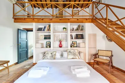 a bedroom with a large bed and a staircase at iFlat Shabby Chic Apartament in Rome